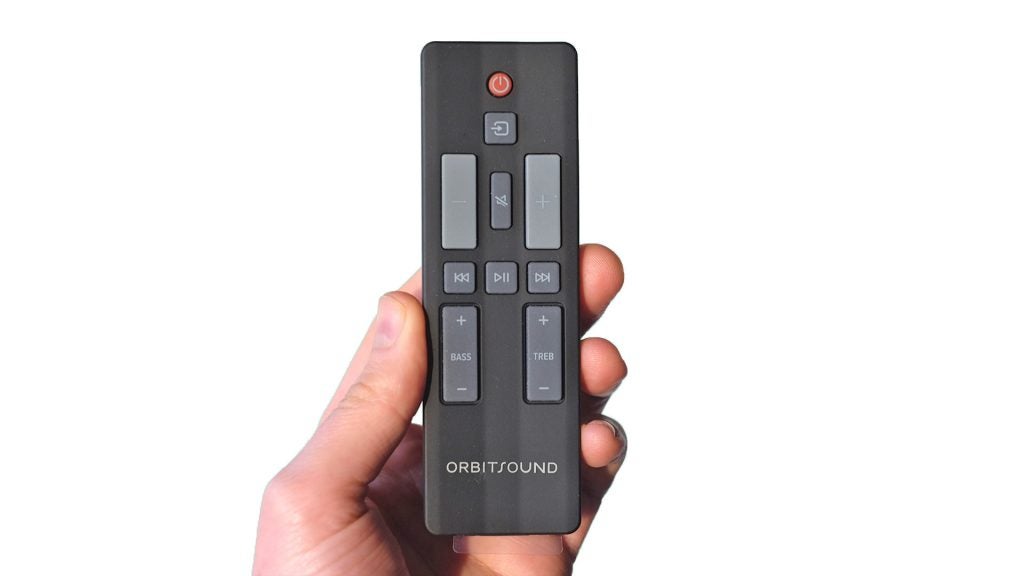 Hand holding Orbitsound E30 soundbar remote control.