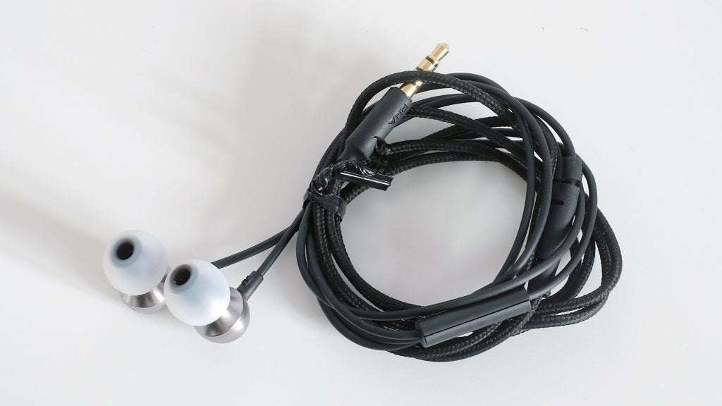 Coiled RHA MA390 earbuds with braided cable on white background.
