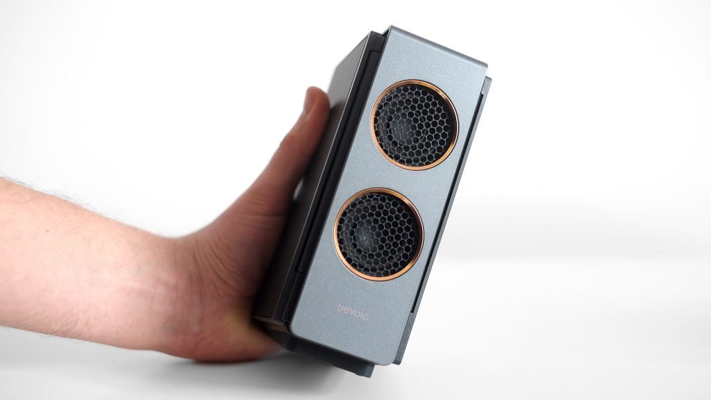 Hand holding BenQ Trevolo S electrostatic Bluetooth speaker.