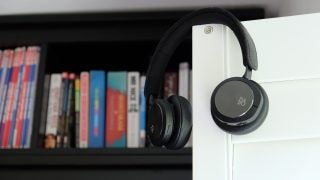 B&O Beoplay H8i headphones resting on a white shelf