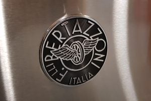 Close-up of Bertazzoni logo on stainless steel appliance.