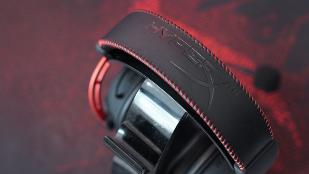 Close-up of HyperX Cloud Alpha gaming headset with red stitching.