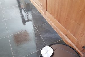 Ecovacs Deebot R95 robot vacuum cleaning a tiled floor.