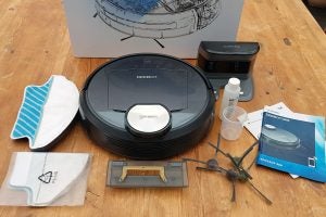Ecovacs Deebot R95 robot vacuum with accessories and manuals.