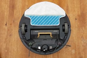 Ecovacs Deebot R95 robotic vacuum with mop attachment on wood floor.