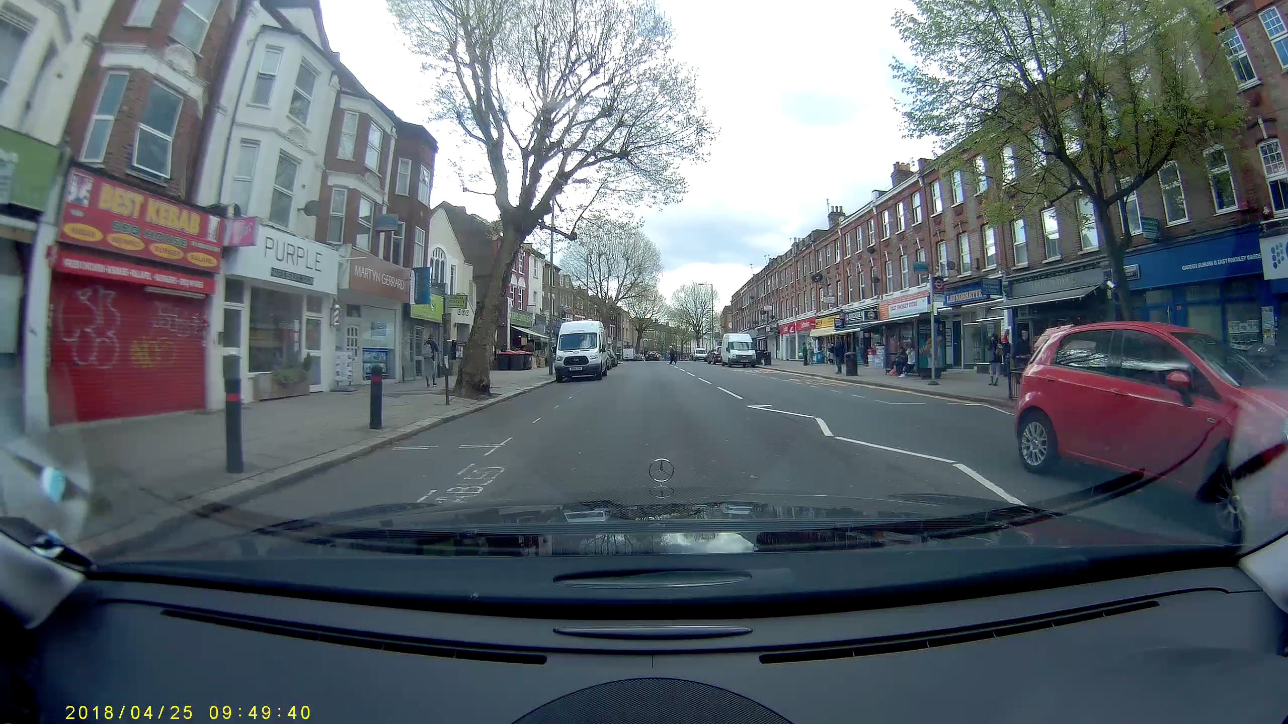 Dashboard camera view of a street scene with vehicles.