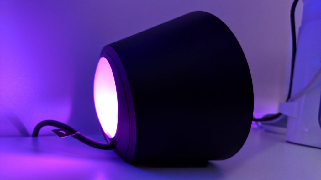 Logitech G560 Lightsync speaker with glowing purple light