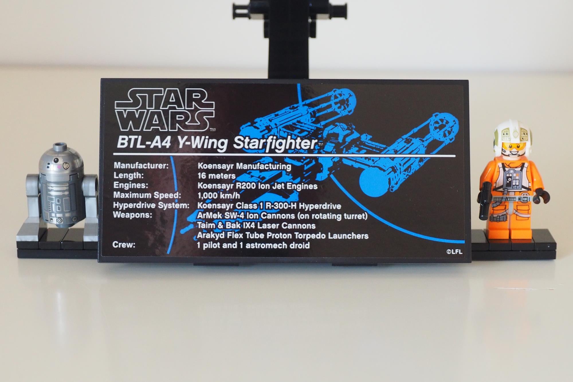 LEGO Star Wars Y-Wing model with information plaque and figures.