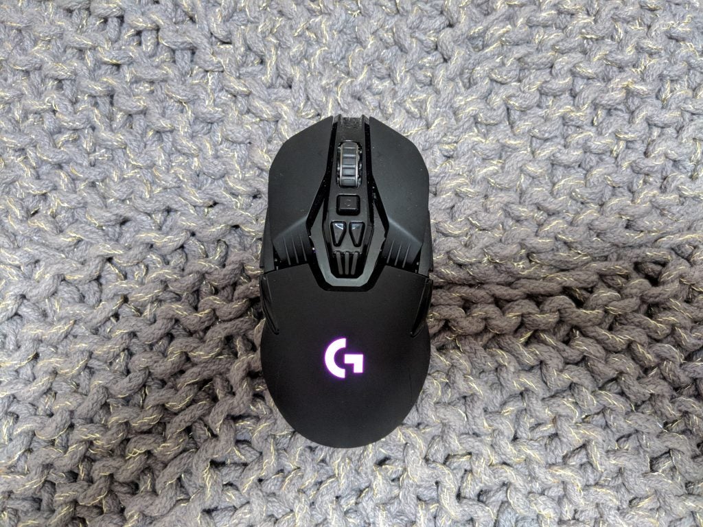 Logitech G903 wireless gaming mouse on textured surface.