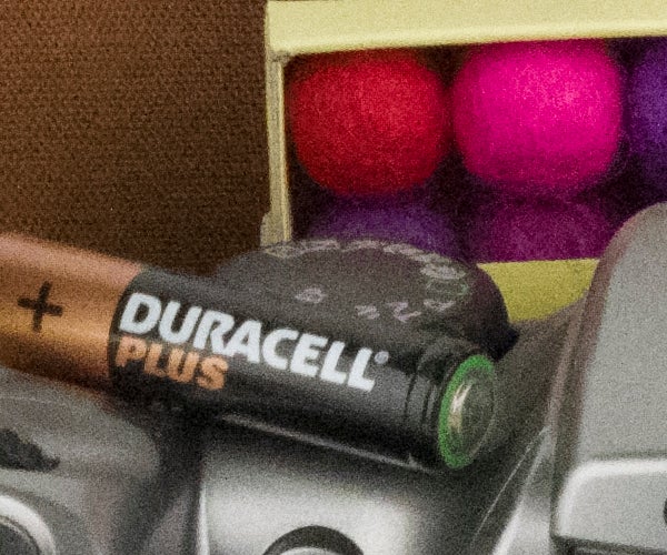 Close-up of a Duracell Plus battery on a camera.