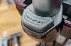 Close-up of Shark vacuum's wand release button.