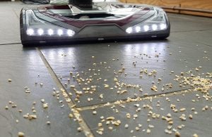 Shark Lift-Away NV681UKT vacuum cleaner with LED lights on floor.