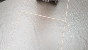 Shark Lift-Away vacuum cleaning rice grains on tiled floor.