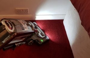 Shark Lift-Away NV681UKT vacuum cleaner on red carpet.
