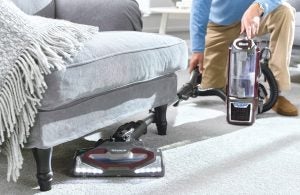 Shark Lift-Away NV681UKT vacuum cleaner being used on carpet.