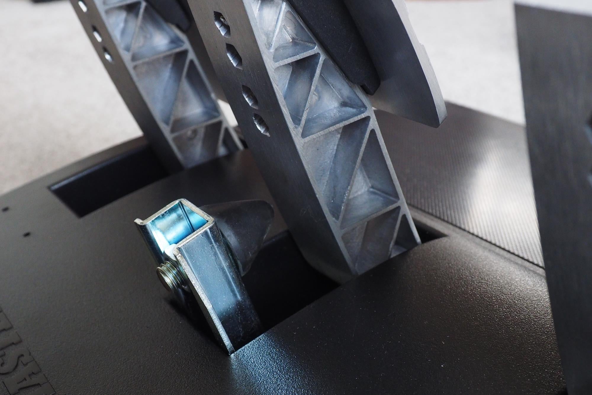 Close-up of Thrustmaster T-GT racing simulator pedals.