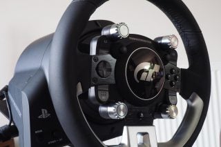 Close-up of Thrustmaster T-GT racing wheel with PlayStation logo