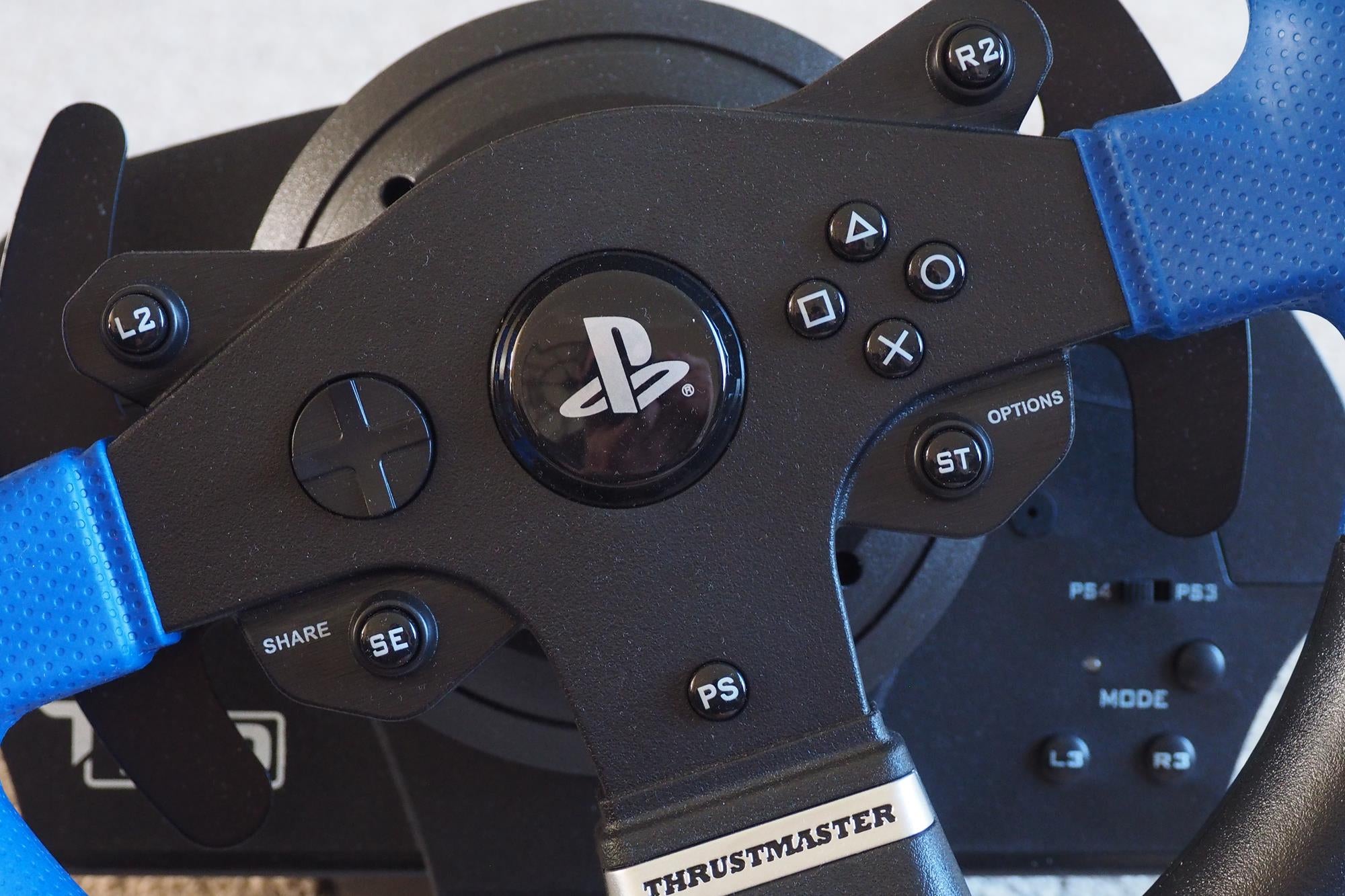 Close-up of Thrustmaster T150 Pro racing wheel with PlayStation controls