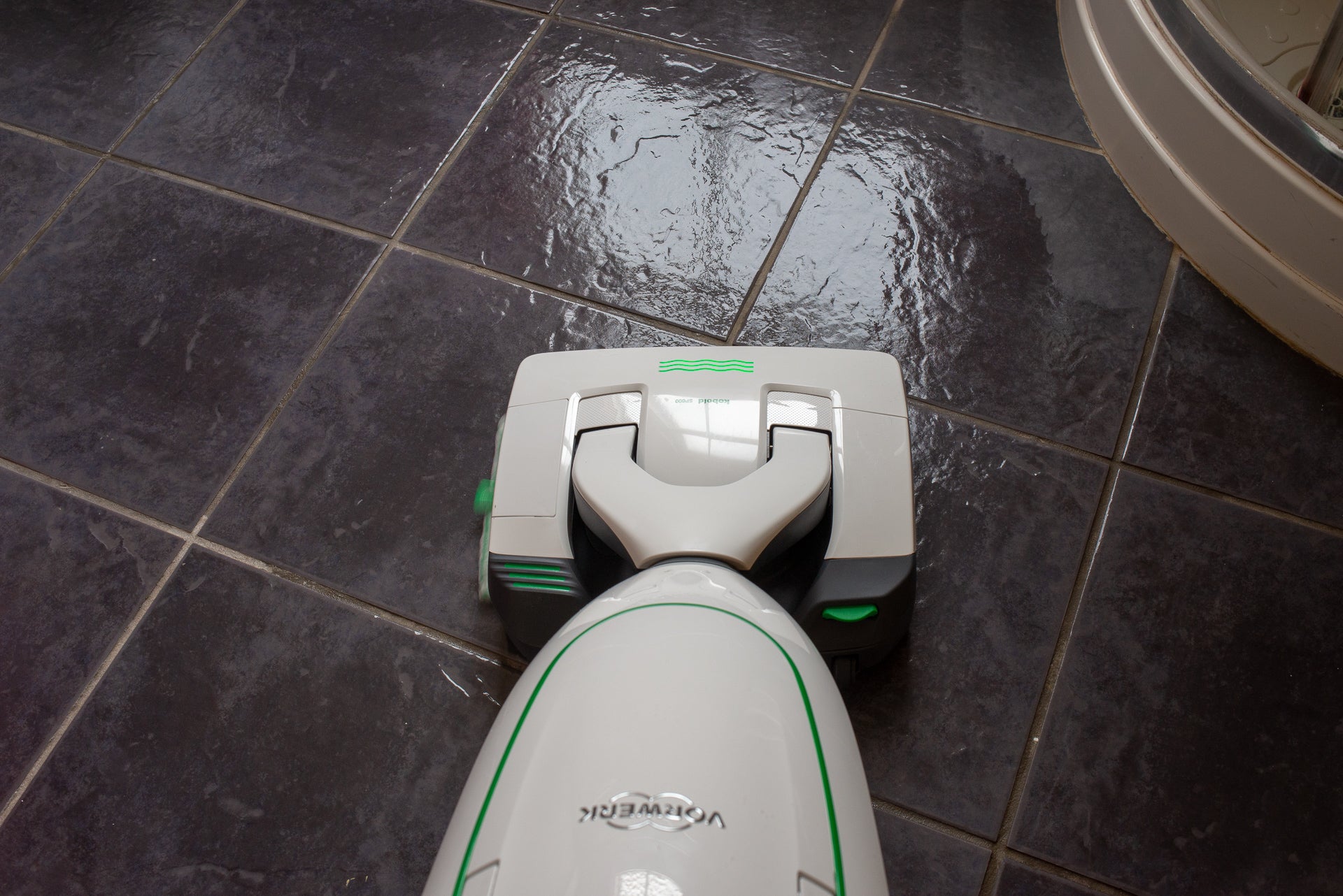 Vorwerk Kobold VK200 vacuum cleaner on a tiled floor.
