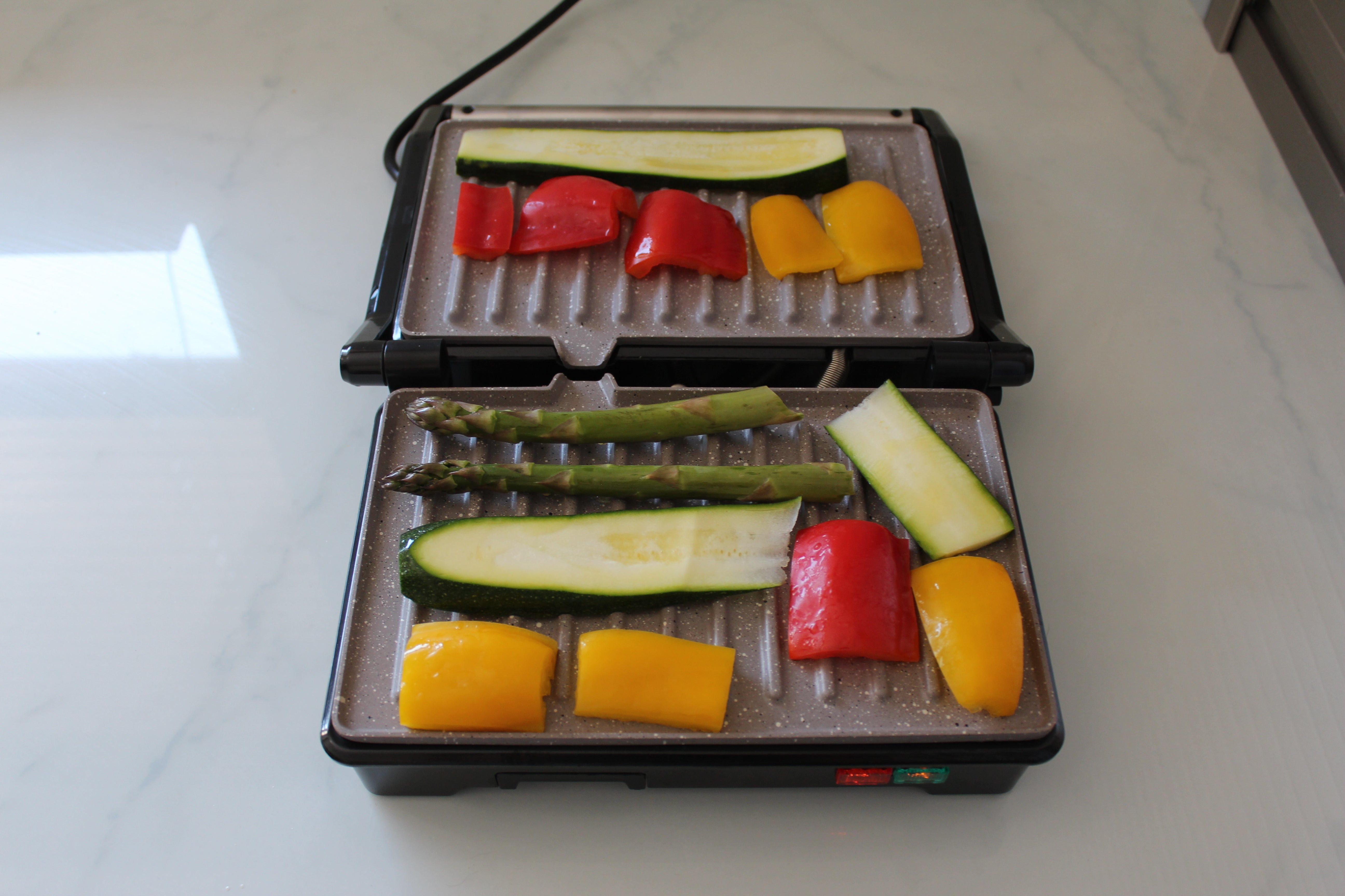 Weight Watchers grill with vegetables cooking on it.