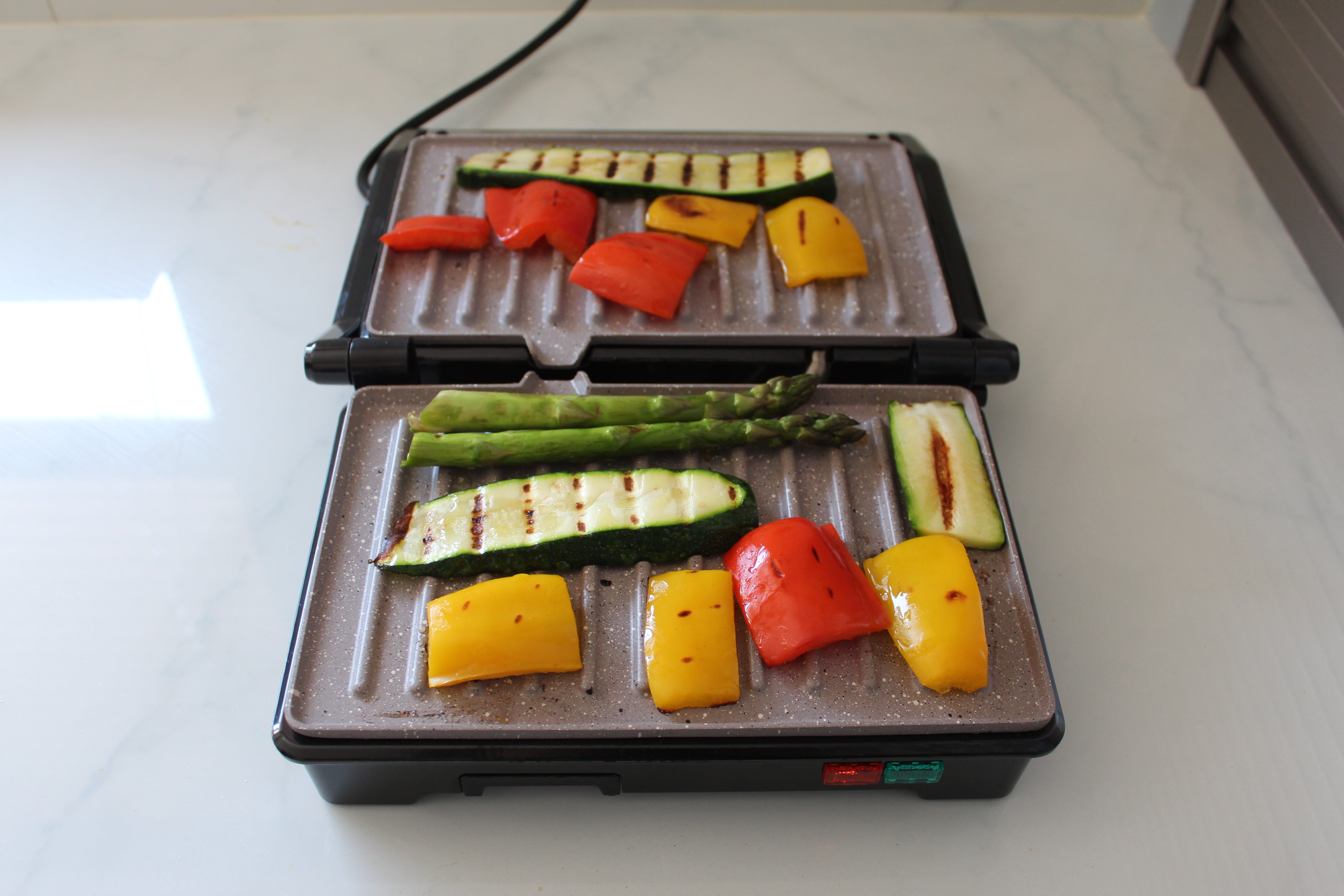 Weight Watchers grill with assorted vegetables cooking.