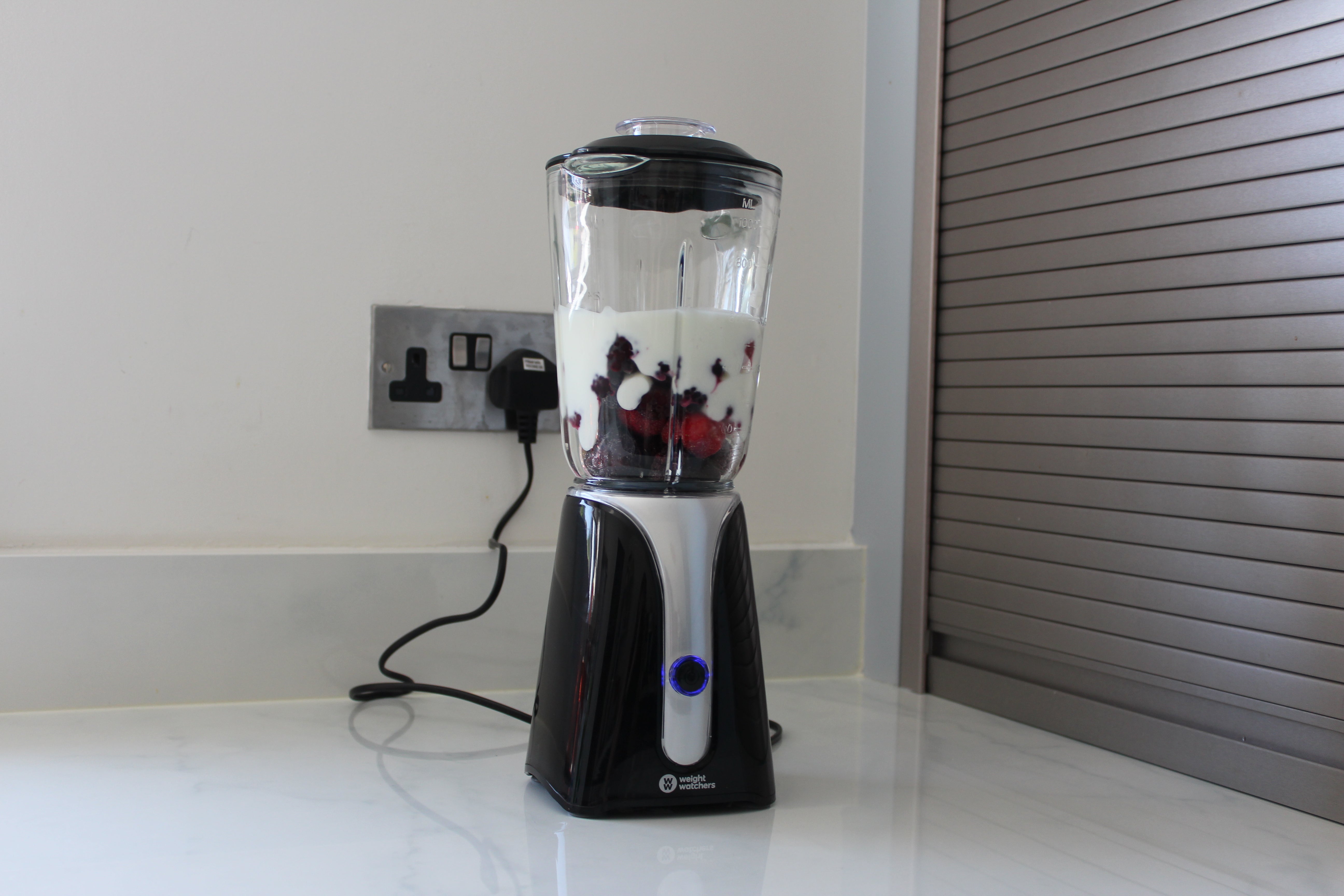Weight Watchers blender with fruits and milk on kitchen counter