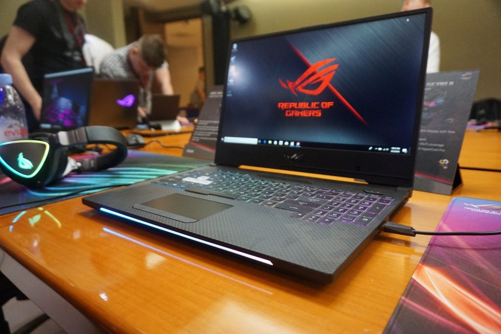 Asus ROG Strix Scar II laptop on a desk at a gaming event.