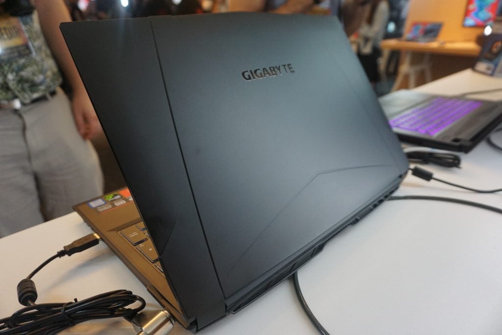 Gigabyte Sabre laptop on display with backlit keyboard visible.
