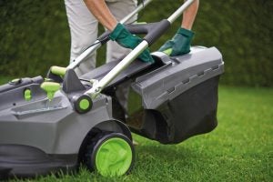 Person using a Gtech Falcon Cordless Lawnmower on grass.