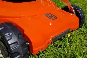 Close-up of Husqvarna LC 347VLi lawn mower on grass.