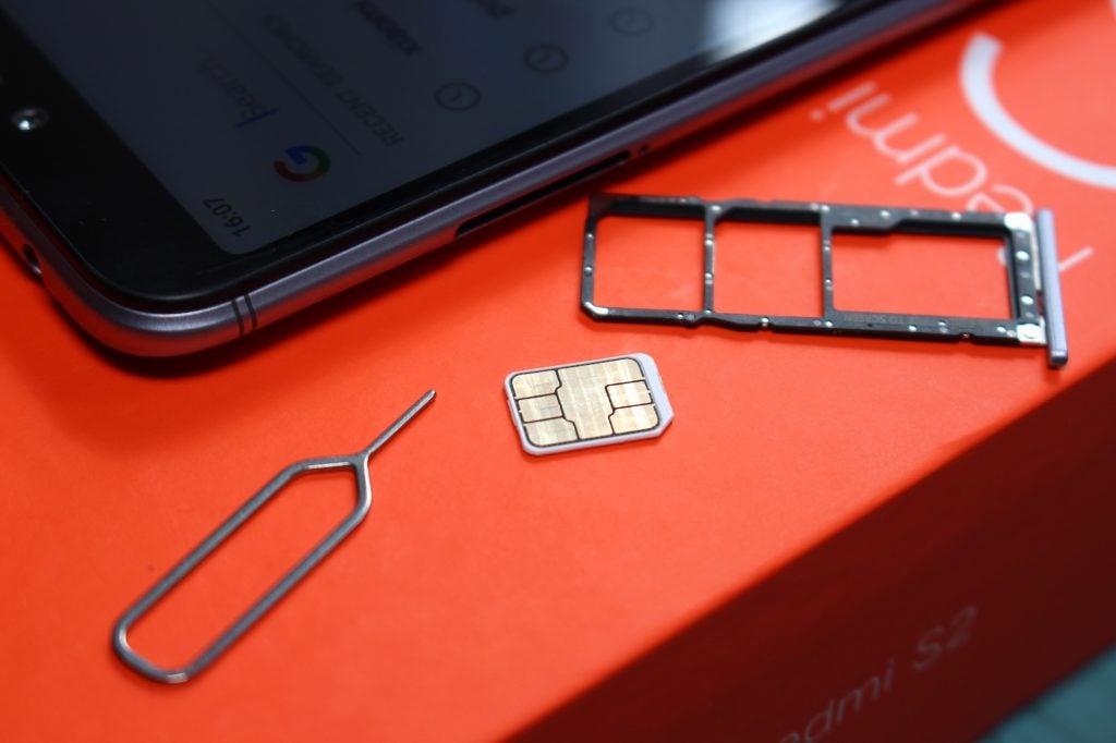 Xiaomi Redmi S2 phone with SIM card tray and ejector tool.