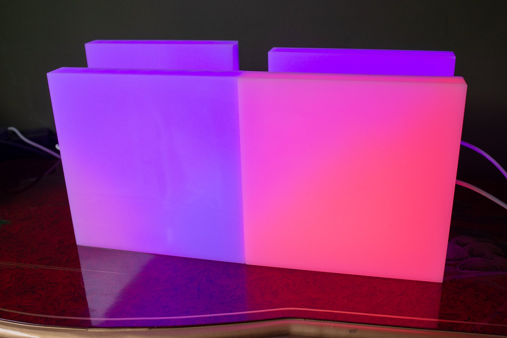 LIFX Tile smart lights displaying purple and pink colors.LIFX Tile LED panels displaying purple and pink colors.