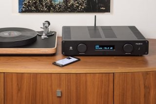 Leema Acoustics Pulse IV amplifier on a wooden desk with turntable.