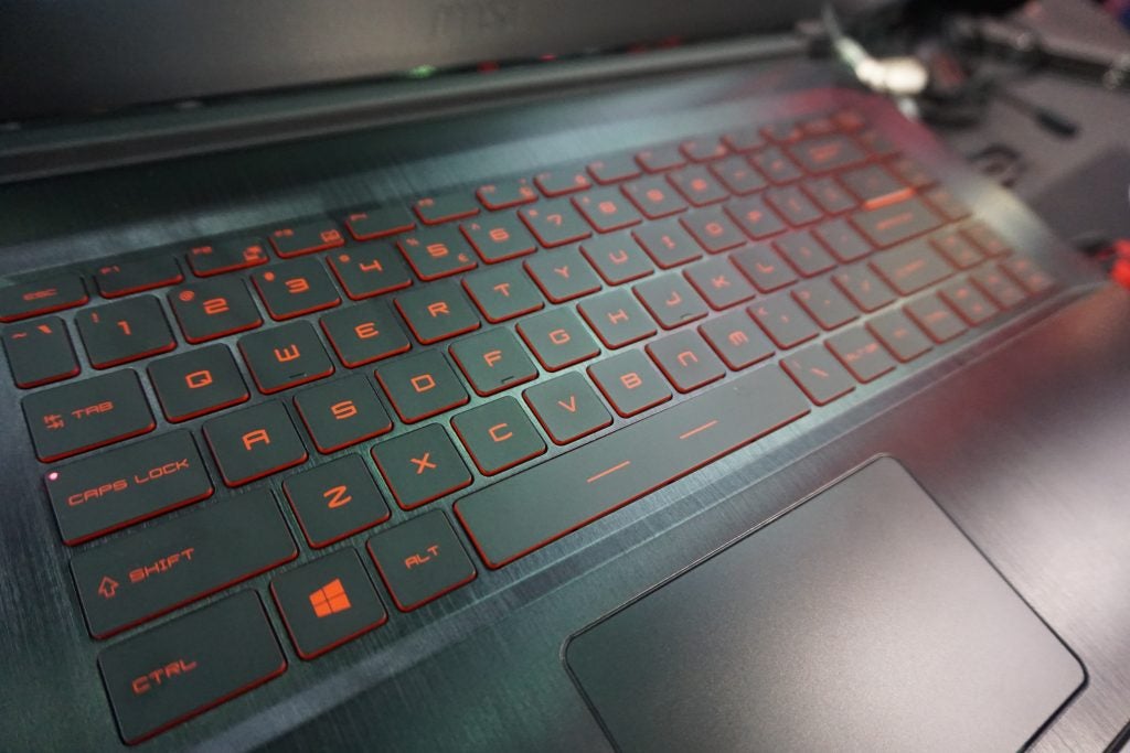 Close-up of MSI GF63 gaming laptop keyboard with red backlight.