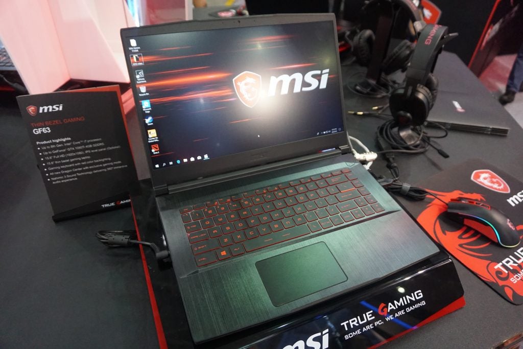 MSI GF63 gaming laptop on display with accessories.