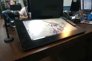 Wacom Cintiq Pro 24 graphic tablet on desk with stylus.