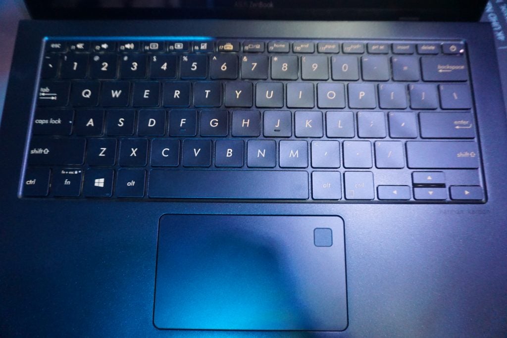 Close-up of Asus ZenBook laptop keyboard and screen.