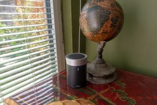 iLuv Aud Click portable speaker next to a vintage globe on a table