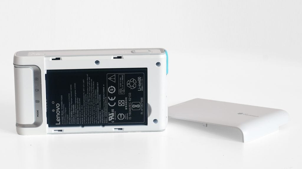 Lenovo Mirage Camera with open battery compartment next to cover.