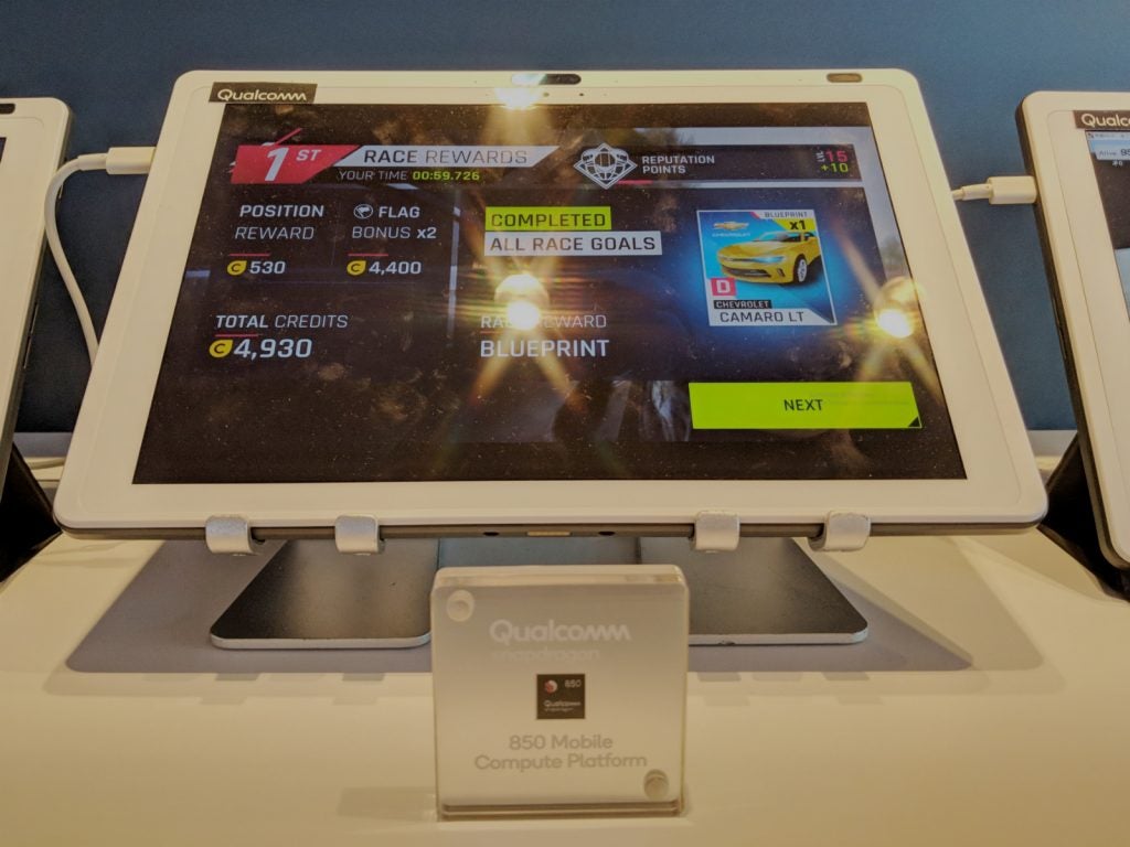 Tablet displaying racing game with Qualcomm Snapdragon 850 signage