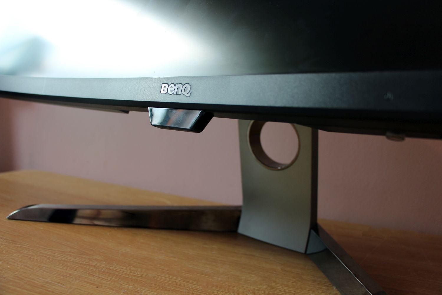 Close up view of BenQ logo on a black BenQ EX3501R montior standing on a table