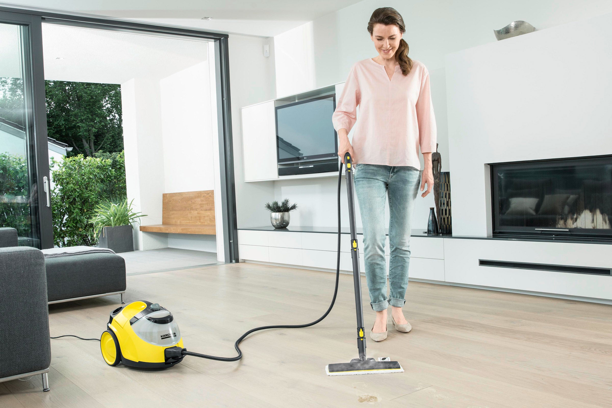 Lifestyle shot of Karcher SC 5 Steam Cleaner being used to clean a hard floor
