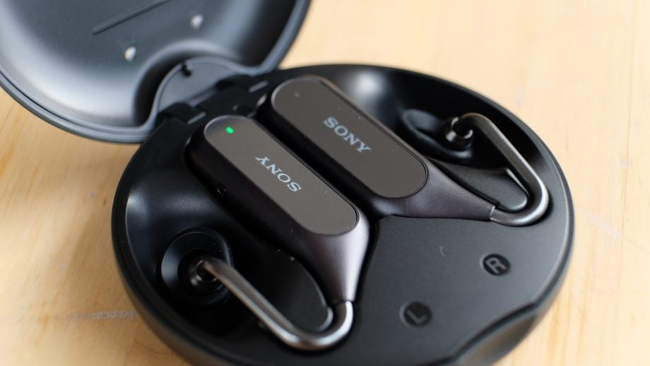 Left angled view of Sony Xperia Ear Duo's black case with earbuds resting in it