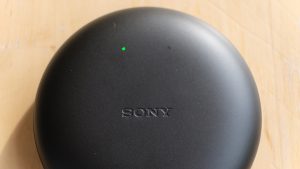 View from top of Sony Xperia Ear Duo earbud's black case kept on tableLeft angled view of Sony Xperia Ear Duo's black case with earbuds resting in it