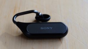 Back panel view of a black Sony Xperia Ear Duo's earbud kept on table