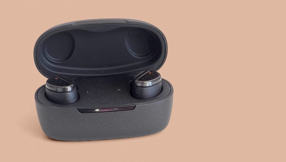 Black Optoma earbuds resting in it's black case standing on a pink background