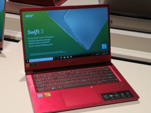 The Acer Swift 3 (2018) in metallic red, opened up, screenset to 10 percent brightness.