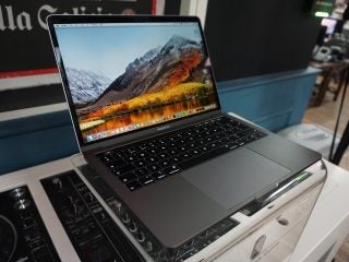 The 13-inch 2018 MacBook Pro open, with the default High Sierra image set as the background.
