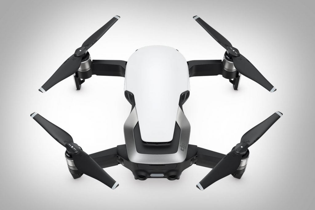A white, gray and black DJI Mavic Air 2 drone kept on a white background