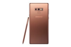 Back panel view of a brown Samsung Galaxy Note 9 standing on white background with S-Pen leaning beside
